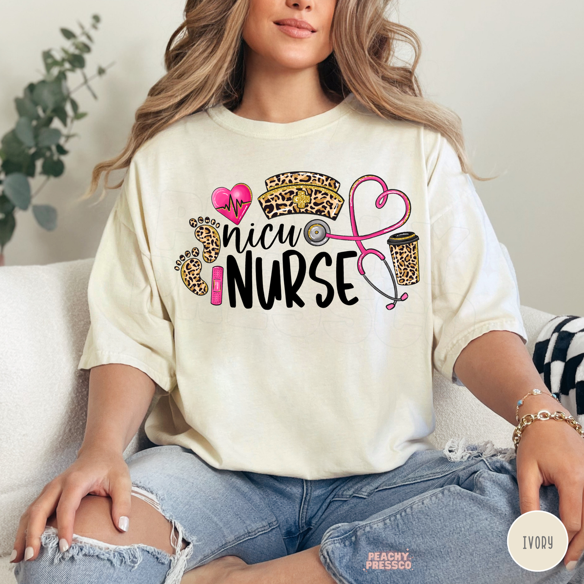 Ivory NICU nurse T-shirt with black NICU Nurse lettering, leopard print footprints, pink heart, leopard coffee cup and stethoscope design.