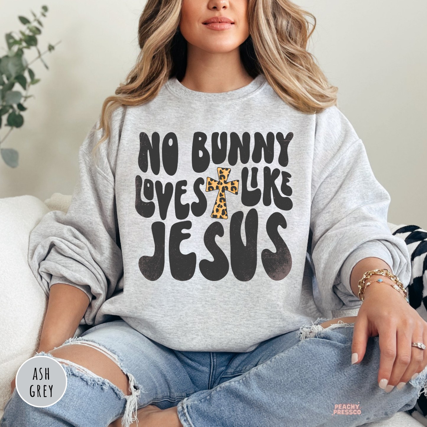 Ash grey crewneck sweatshirt featuring a No Bunny Loves Like Jesus Christian Easter graphic with a leopard print cross.