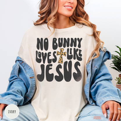 Ivory shirt displaying a No Bunny Loves Like Jesus Christian Easter graphic with a leopard print cross.
