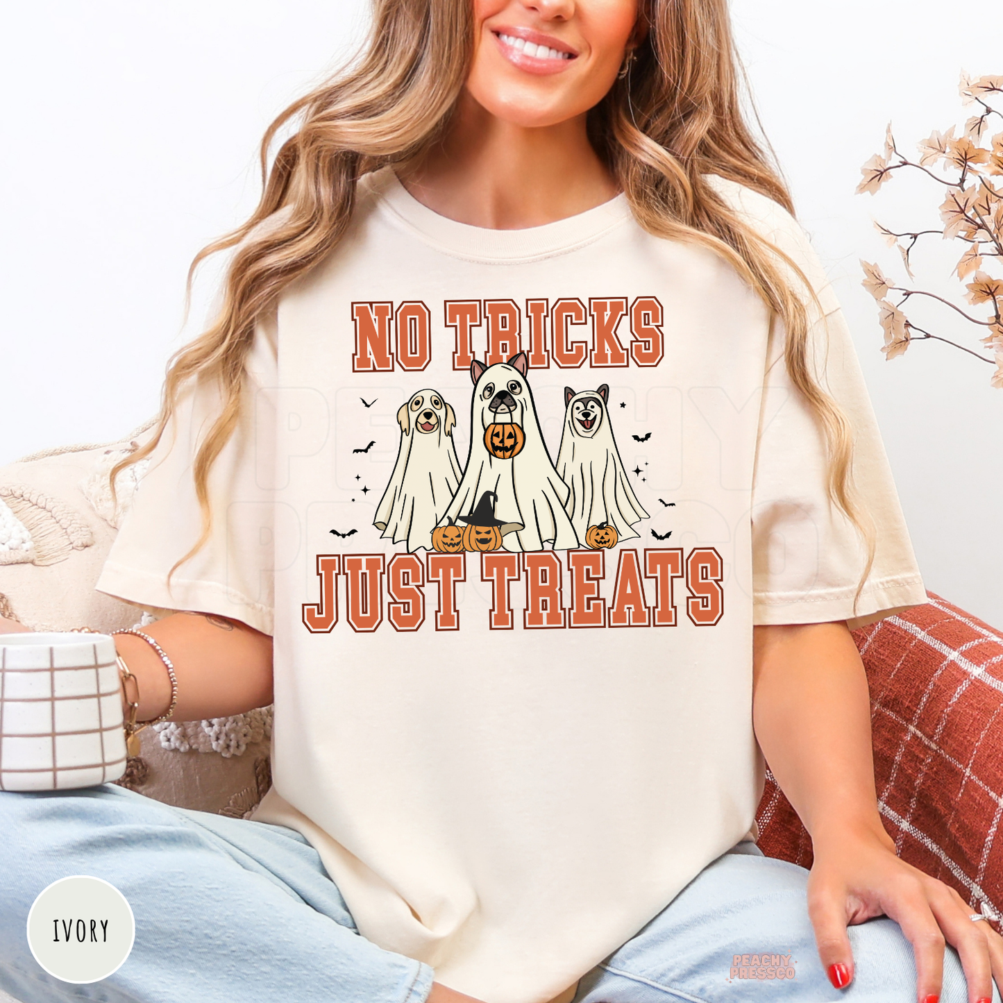 Ivory No Tricks Just Treats Halloween dog shirt featuring three dogs dressed as ghosts with pumpkins and bats