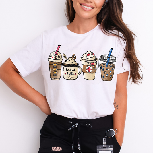 White nurse coffee lover T-shirt featuring four cute coffee drinks, Nurse Fuel lettering, a pink medical cross and stethoscope, paired with black scrub pants.