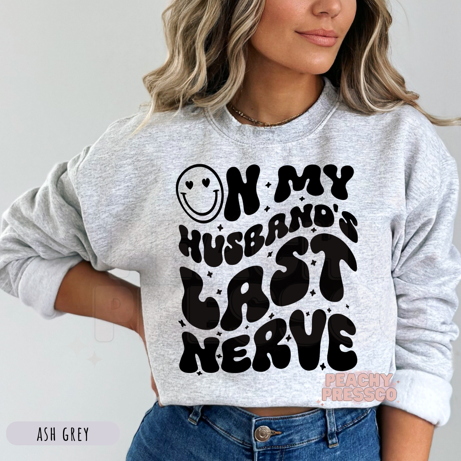 Ash Grey sweatshirt featuring a trendy "On My Husband's Last Nerve" graphic in bold black retro lettering. Cozy funny wife sweatshirt.