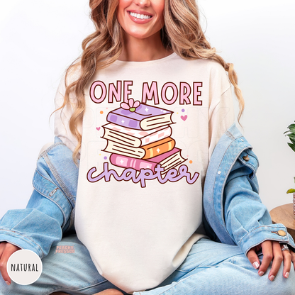 Natural unisex graphic tee featuring a pastel stack of books and "One More Chapter" design for book lovers and readers.