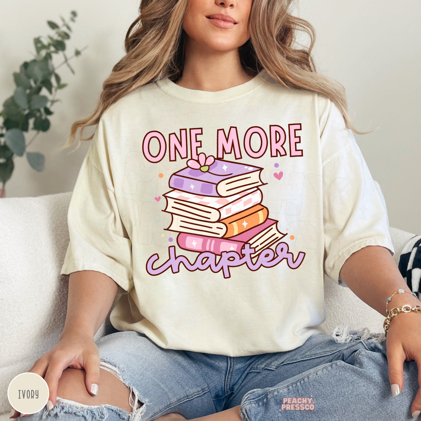 Ivory Comfort Colors graphic tee featuring a pastel stack of books and "One More Chapter" design for book lovers and book club members.