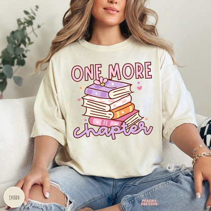 Ivory Comfort Colors graphic tee featuring a pastel stack of books and "One More Chapter" design for book lovers and book club members.