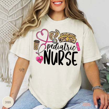 Ivory pediatric nurse T-shirt with leopard print nurse hat and baby footprints, pink stethoscope, heartbeat heart and Pediatric Nurse lettering.