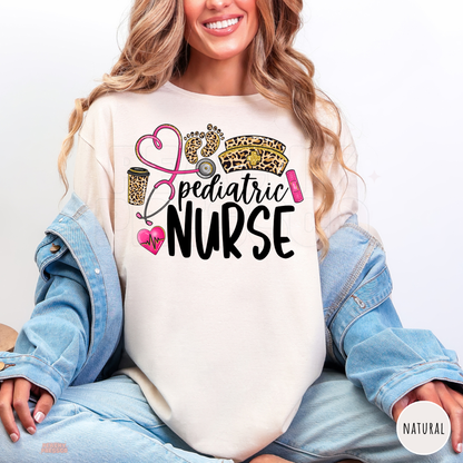 Natural pediatric nurse shirt with leopard print baby footprints, pink stethoscope heart, leopard nurse hat and black Pediatric Nurse lettering.