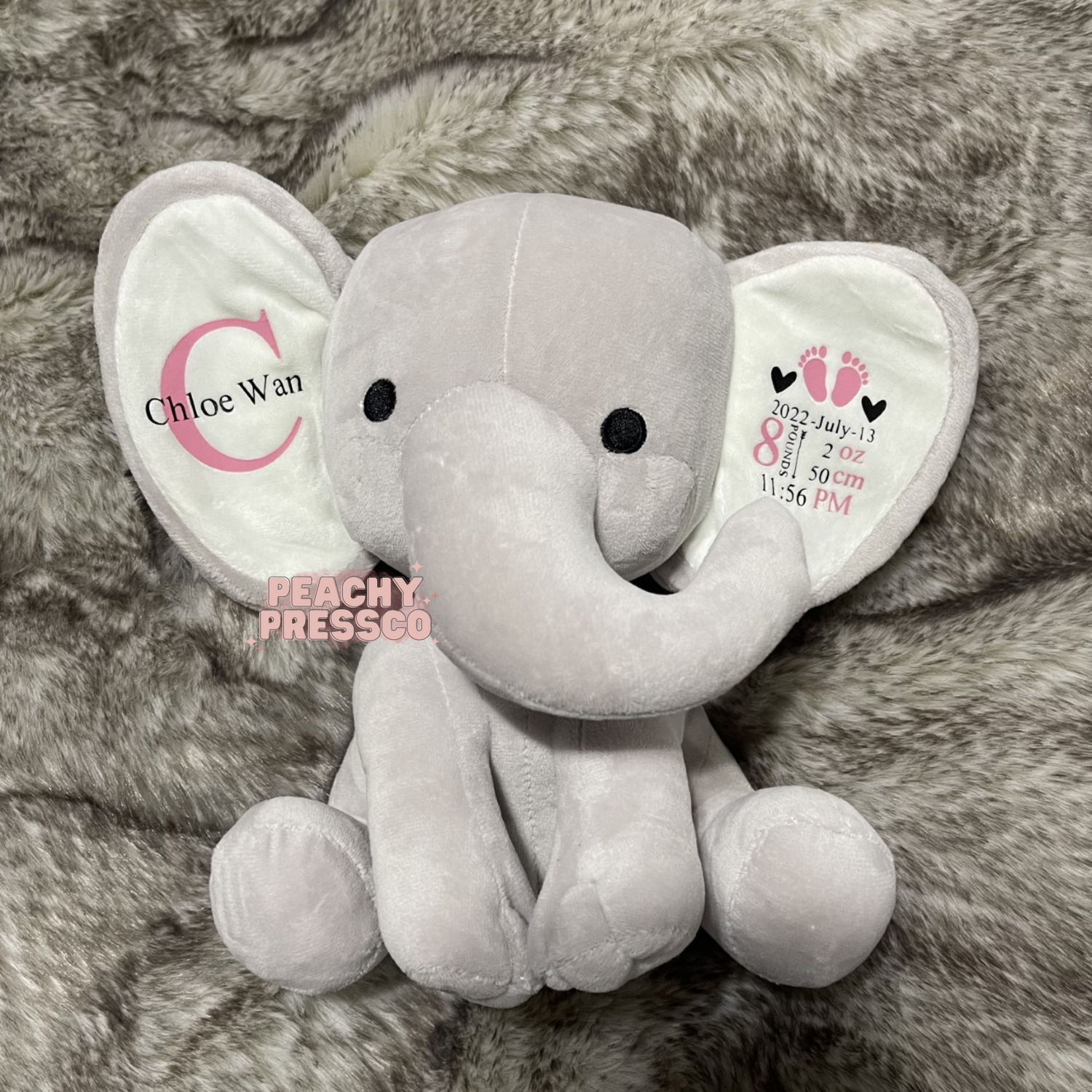 Personalized gray elephant plush featuring a custom baby girl name and embroidered birth statistics including birth date, weight, length, and time, creating a soft newborn keepsake gift.