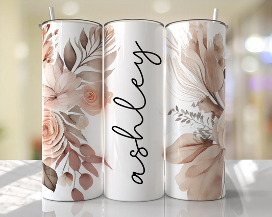 Personalized 20 oz skinny tumbler with neutral beige watercolor florals and custom vertical name in black script. Elegant floral drink tumbler with lid and straw.