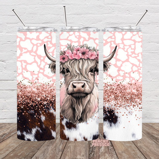 Cute Highland cow wearing a pink floral crown on a pink cow print and rose gold glitter full wrap 20oz skinny tumbler.
