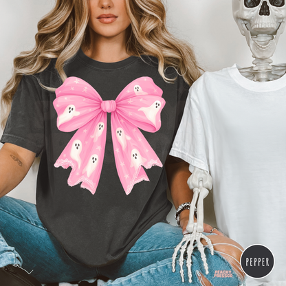 Pepper Halloween graphic tee featuring an oversized pink bow decorated with cute white ghosts and stars