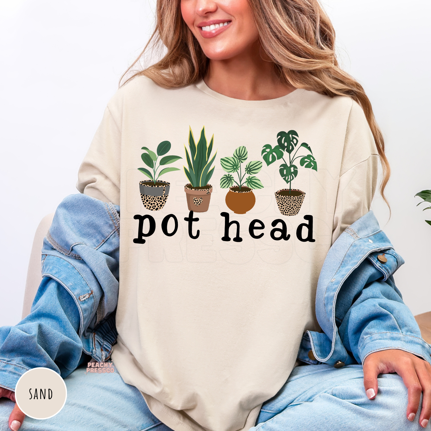 Sand crewneck sweatshirt featuring a playful "Pot Head" design with illustrated houseplants in leopard-print and terracotta pots. Cozy botanical sweatshirt for plant moms and houseplant lovers.