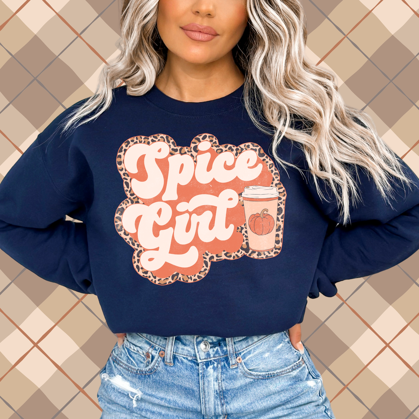 Woman wearing a navy crewneck sweatshirt featuring a Pumpkin Spiced Girl graphic with a pumpkin coffee cup and leopard print for fall.