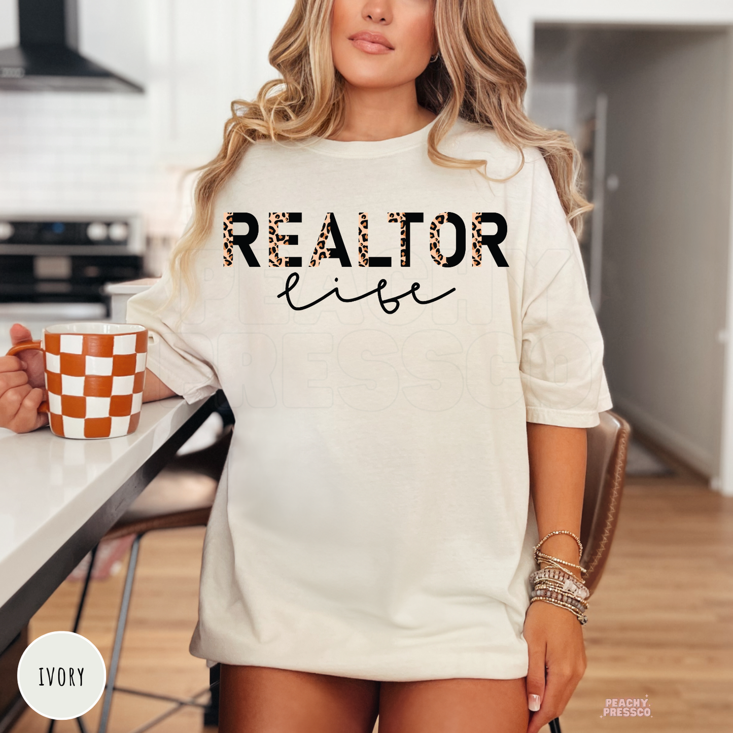 Woman wearing an oversized ivory t-shirt with a Realtor Life leopard print design, a trendy gift for real estate agents and REALTORS.