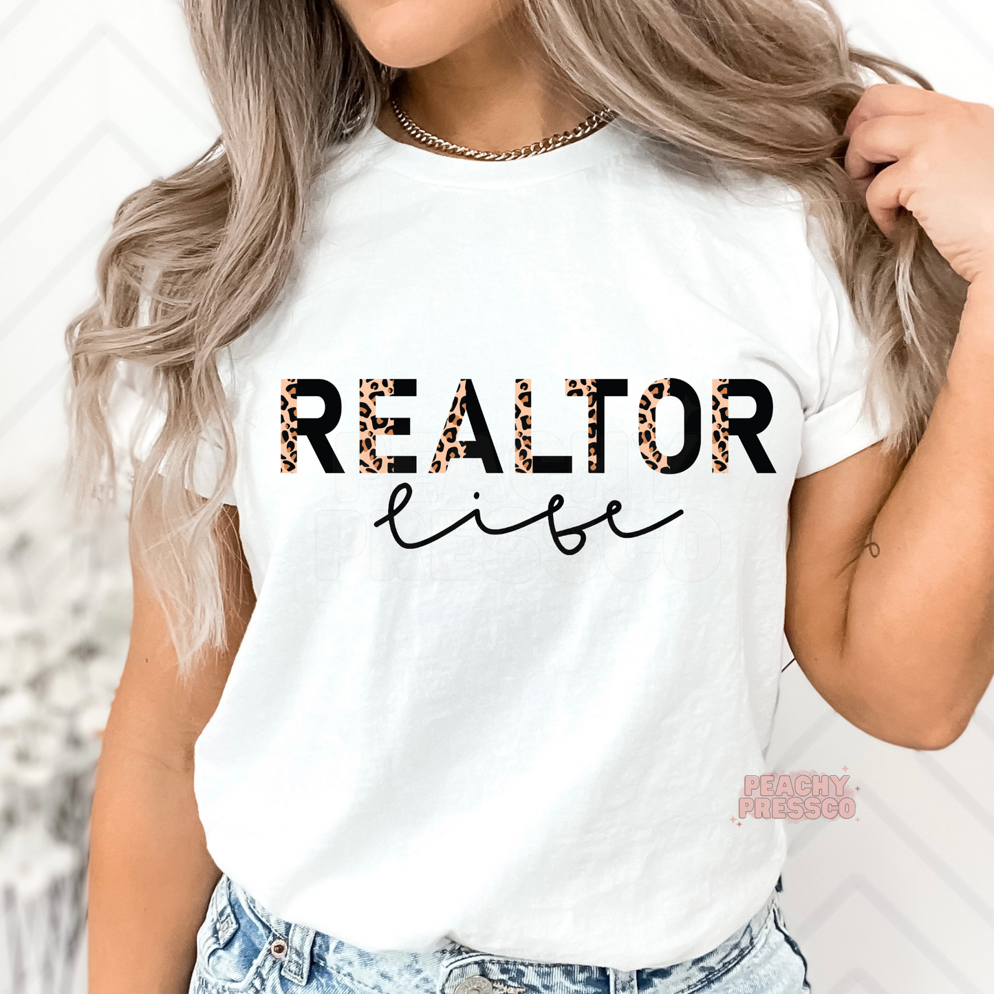 White graphic t-shirt featuring a Realtor Life leopard print design, ideal for real estate professionals, brokers, and property agents.