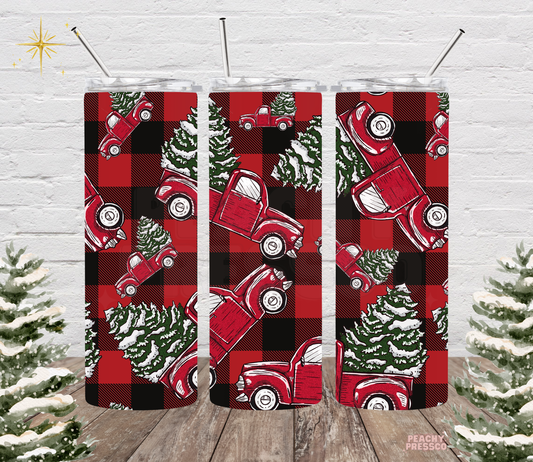 20oz stainless steel tumbler with red and black buffalo plaid background featuring vintage red pickup trucks carrying snowy Christmas trees.