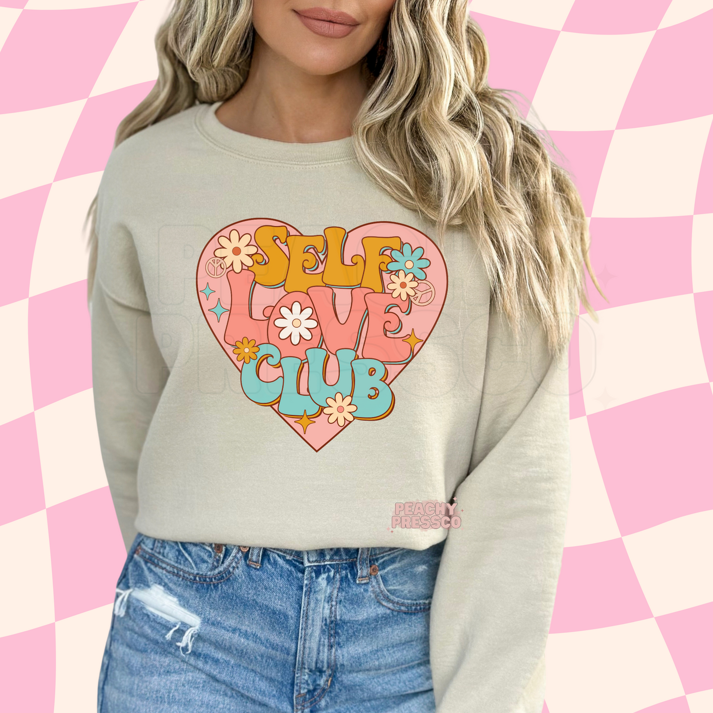 Sand sweatshirt featuring a retro Self Love Club graphic with a pink heart, groovy lettering, colorful flowers, and vintage-inspired details.