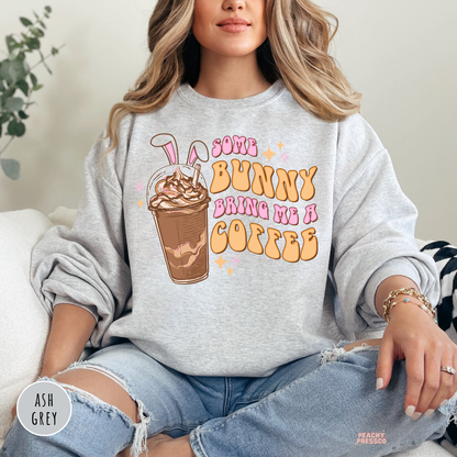 Ash grey crewneck sweatshirt featuring a Some Bunny Bring Me A Coffee Easter graphic with iced coffee and bunny ears.