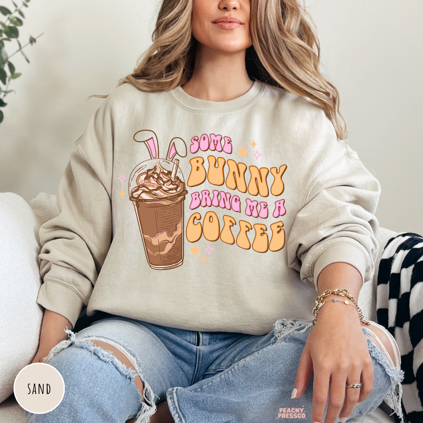 Sand crewneck sweatshirt with a retro Some Bunny Bring Me A Coffee Easter design featuring a bunny ear iced coffee.