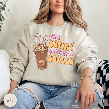 Sand crewneck sweatshirt with a retro Some Bunny Bring Me A Coffee Easter design featuring a bunny ear iced coffee.