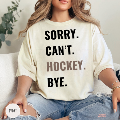Ivory unisex graphic t-shirt with the funny "Sorry. Can't. Hockey. Bye." design for hockey enthusiasts.
