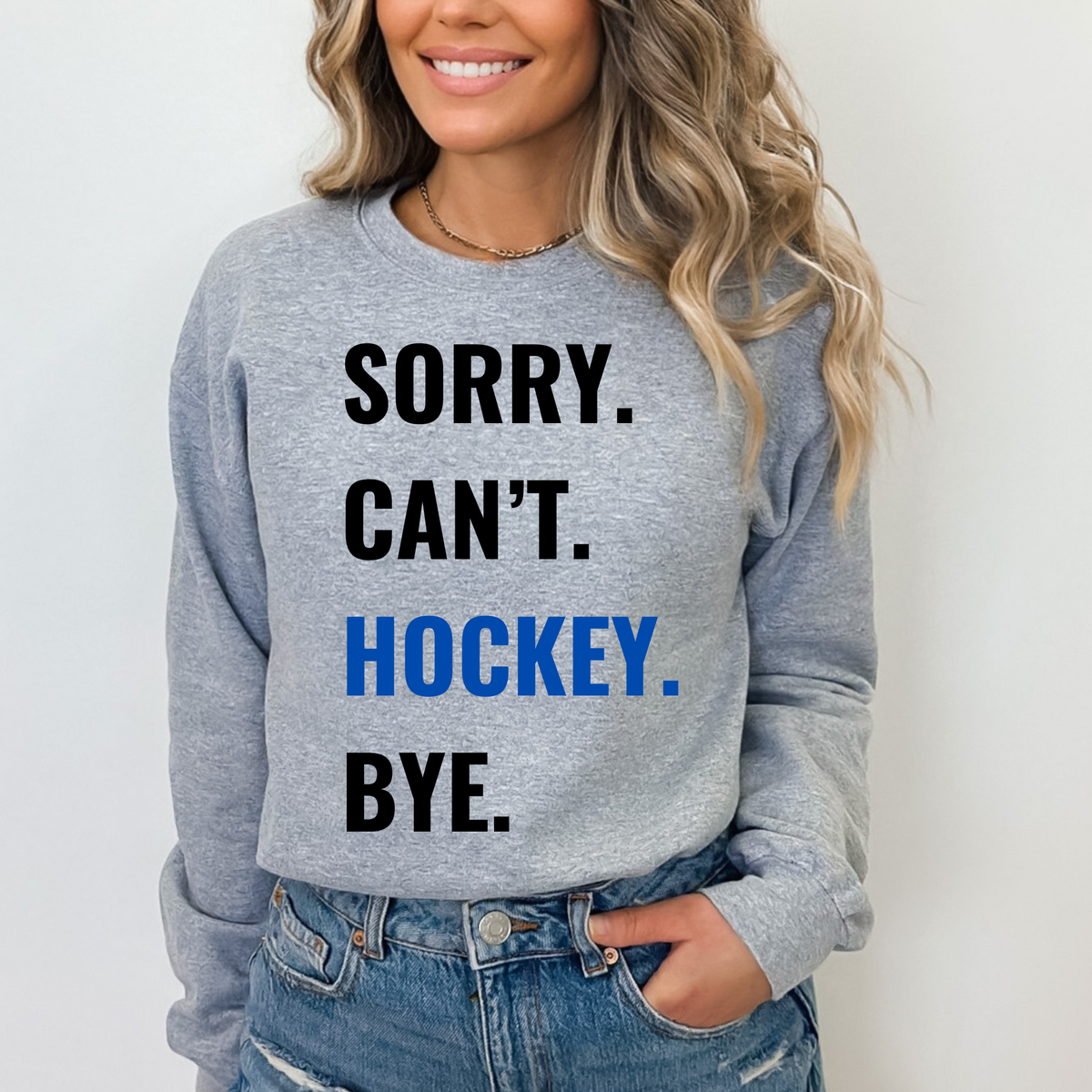 Sport grey crewneck sweatshirt with blue "Hockey" text and funny hockey fan slogan.