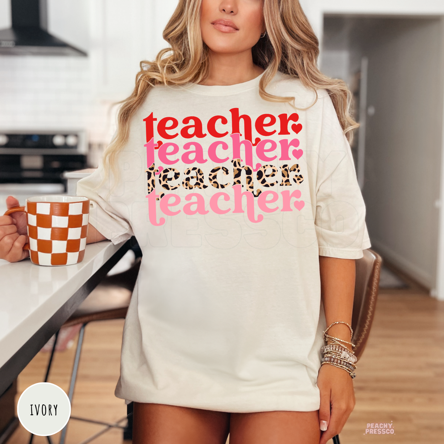 Ivory unisex teacher shirt showcasing a stacked Valentine teacher graphic with retro typography and trendy leopard print accents.