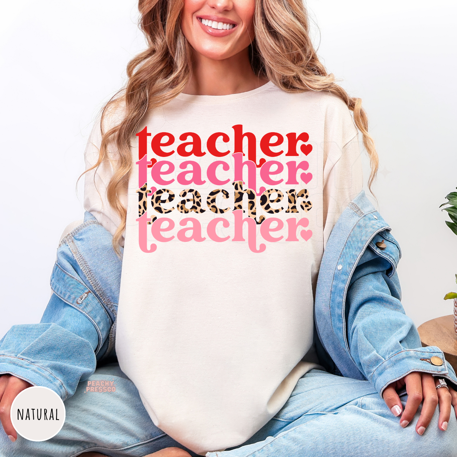 Natural shirt featuring a stacked Valentine teacher typography design with layered pink lettering, leopard print accents, and retro style.