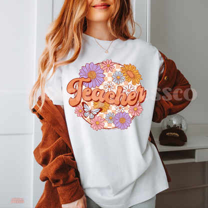 White teacher t-shirt featuring vintage floral "Teacher" design with pastel flowers, butterfly, and peach checkerboard background.