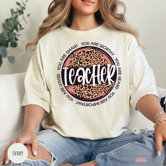 Ivory Comfort Colors teacher t-shirt with a leopard print teacher design surrounded by positive affirmations for educators and classrooms.