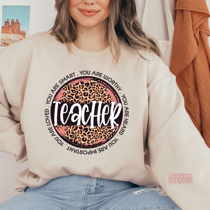 Sand teacher sweatshirt with a pink leopard print teacher design and uplifting affirmations celebrating educators and students.