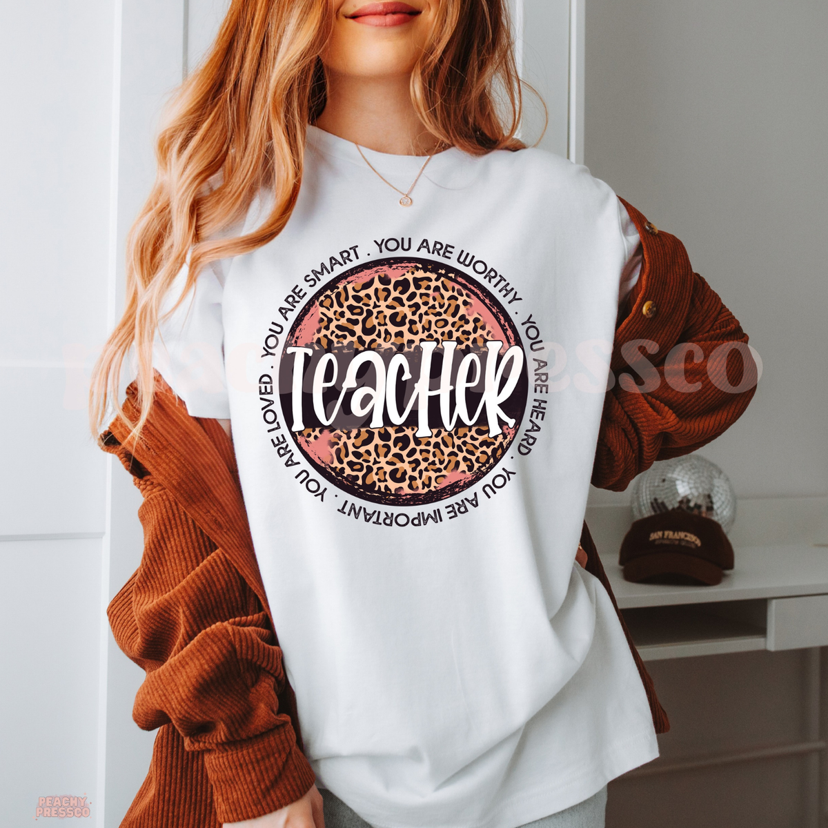 White teacher t-shirt featuring a leopard print teacher graphic with inspirational classroom affirmations around the design.