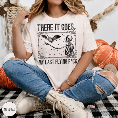 Natural There It Goes Halloween T-shirt featuring a funny skeleton and flying bat vintage Halloween graphic
