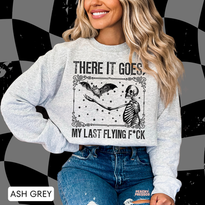 Ash grey There It Goes Halloween sweatshirt featuring a vintage skeleton, flying bat and distressed spooky graphic