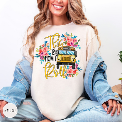 Natural teacher shirt featuring a watercolor floral school bus design with "This Is How I Roll" lettering for teachers.