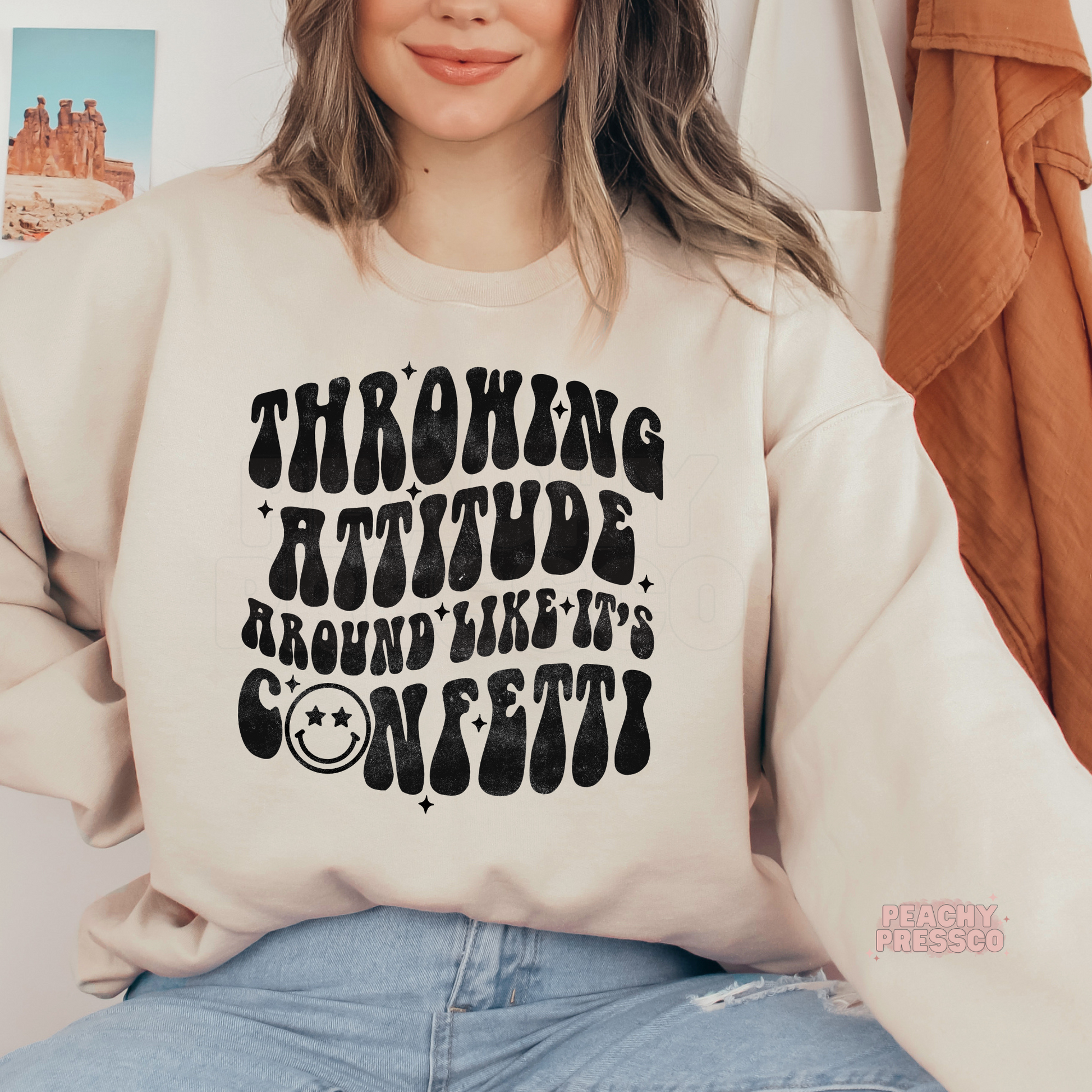 Sand hoodie featuring the "Throwing Attitude Around Like It's Confetti" funny retro graphic with distressed black typography.