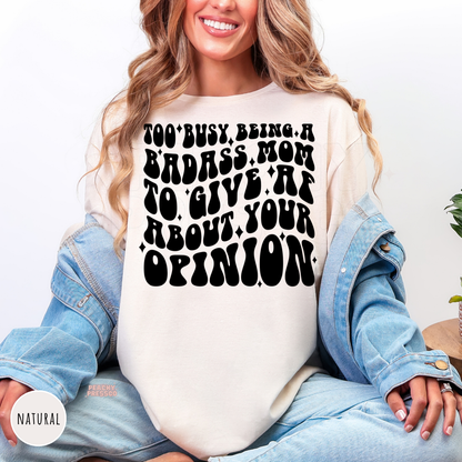 Natural shirt featuring the funny "Too Busy Being a Badass Mom to Give AF About Your Opinion" statement graphic. Perfect Mother's Day or birthday gift for moms.