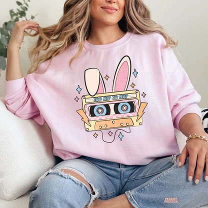 Pink crewneck sweatshirt featuring a retro "Too Hip To Hop" bunny cassette tape graphic with pastel Easter colors.