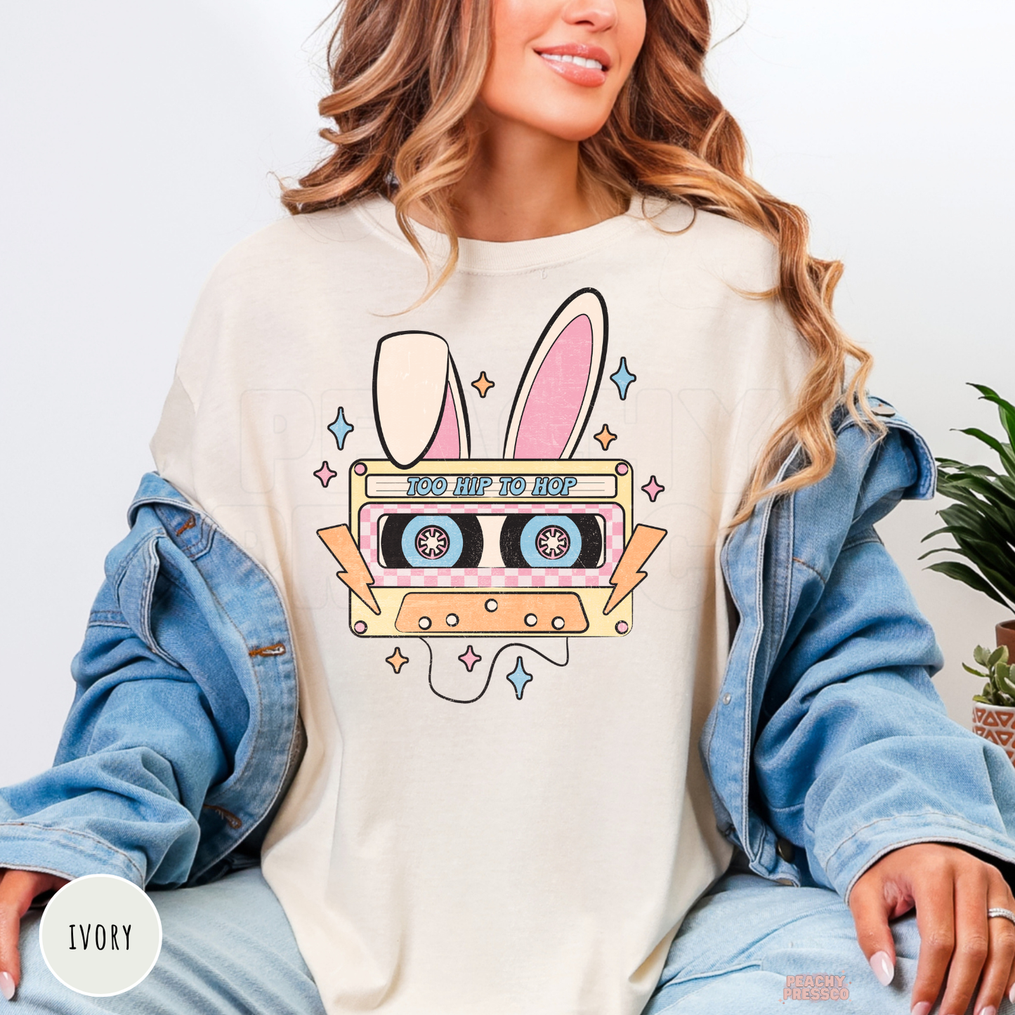 Ivory shirt with a retro "Too Hip To Hop" bunny cassette tape Easter graphic.
