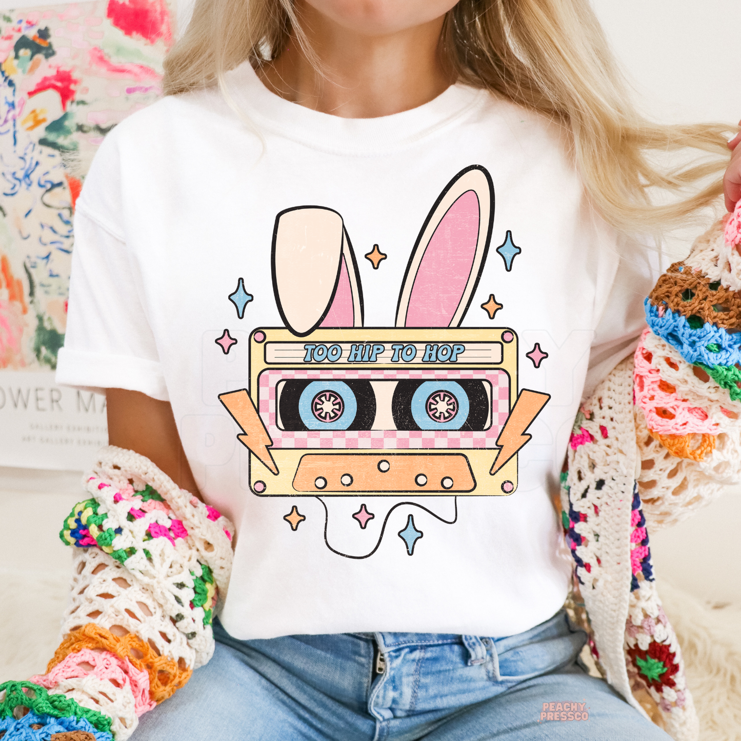 White graphic t-shirt featuring a vintage bunny ears cassette tape with "Too Hip To Hop" Easter design.