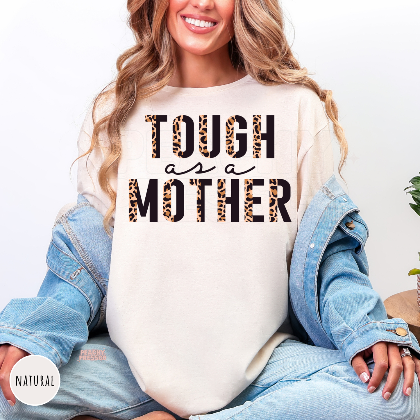 Natural t-shirt featuring a bold leopard print "Tough as a Mother" design. Relaxed-fit graphic tee perfect for busy moms and Mother's Day gifts.