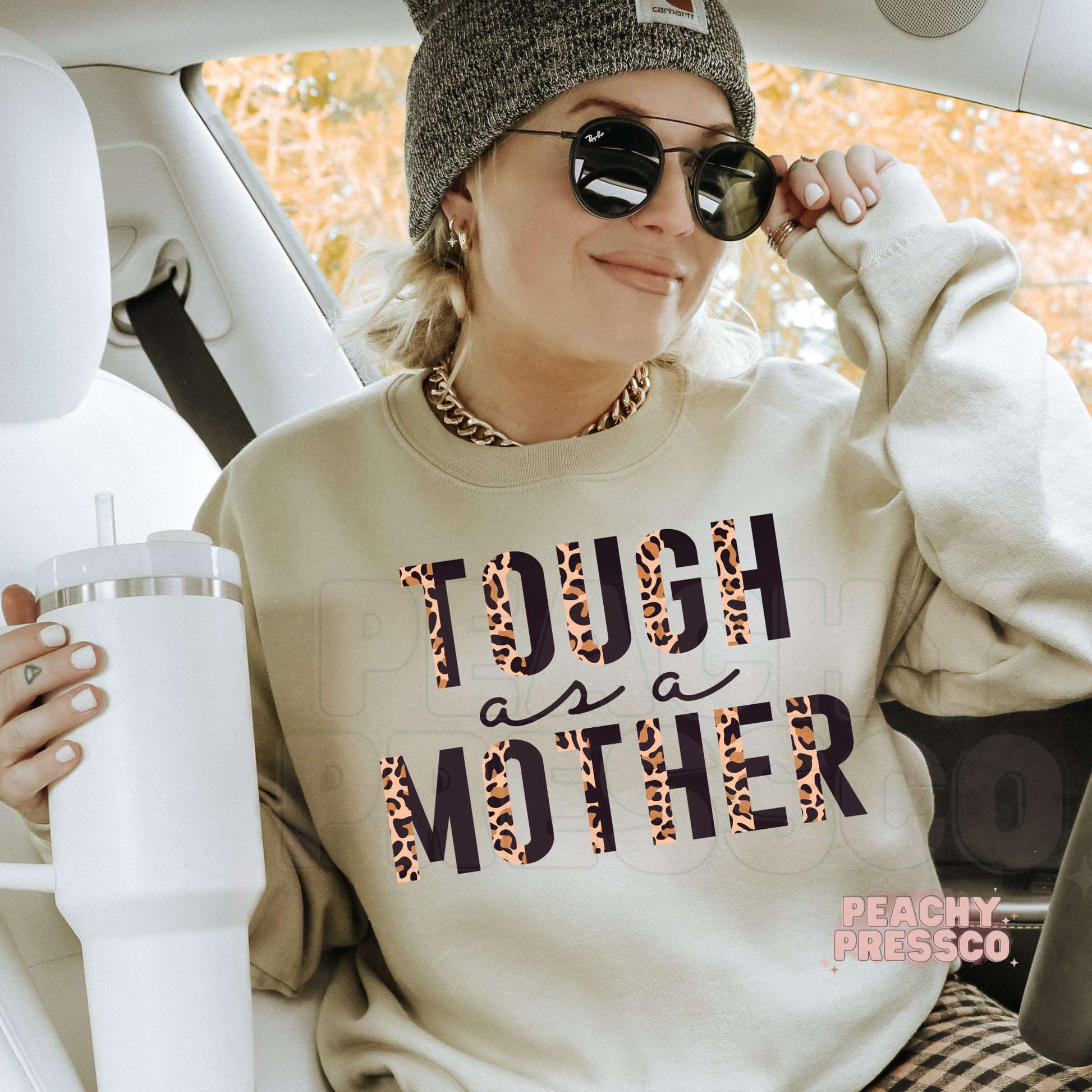 Sand crewneck sweatshirt featuring a bold leopard print "Tough as a Mother" graphic. Comfortable everyday sweatshirt for strong moms.