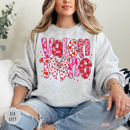 Ash grey crewneck sweatshirt featuring a retro stacked "Valentine" graphic with heart accents and a cute coquette bow.