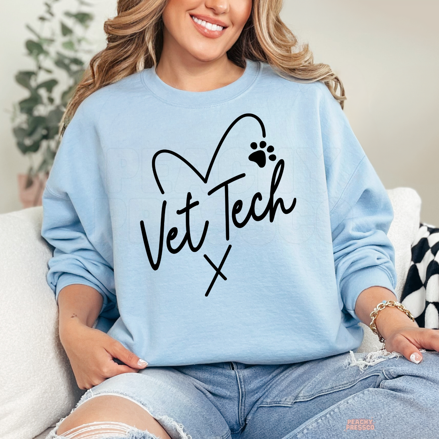 Light blue sweatshirt featuring a Vet Tech heart and paw print graphic, a cozy gift for veterinary technicians and veterinary assistants.
