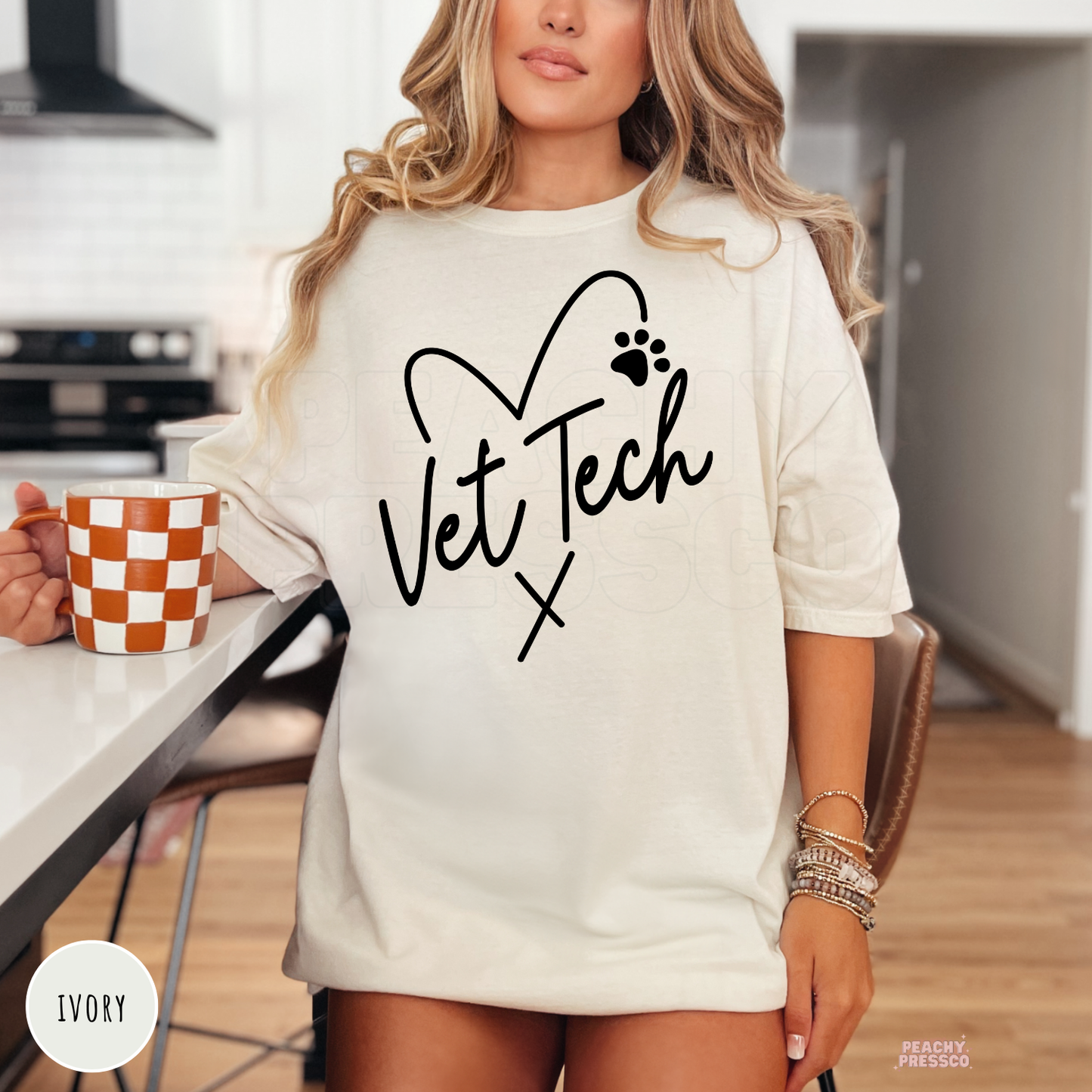 Oversized ivory t-shirt featuring a Vet Tech heart and paw print graphic, stylish gift for veterinary technicians, vet nurses, and animal lovers.