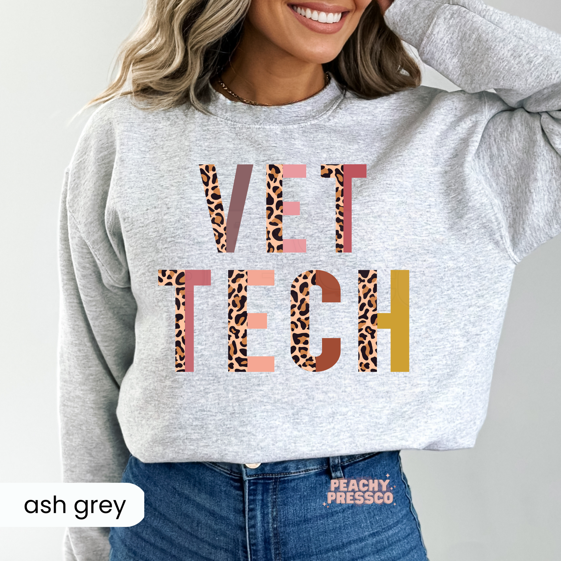 Ash grey sweatshirt displaying a bold leopard print Vet Tech graphic, comfortable veterinary apparel for vet techs, students, and animal care workers.