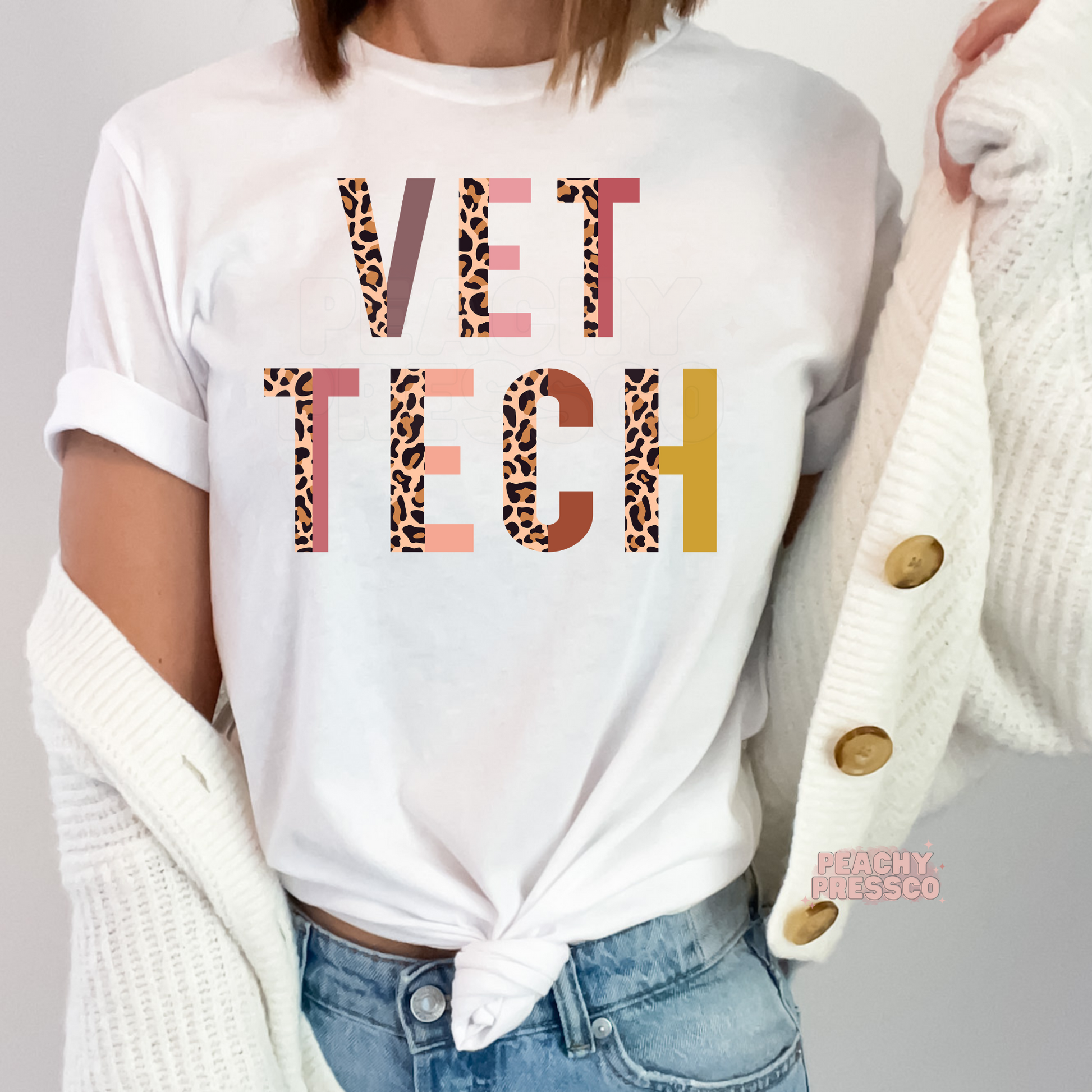 Woman wearing a white t-shirt featuring a colorful leopard print Vet Tech graphic, perfect for veterinary technicians, vet assistants, and veterinary students.