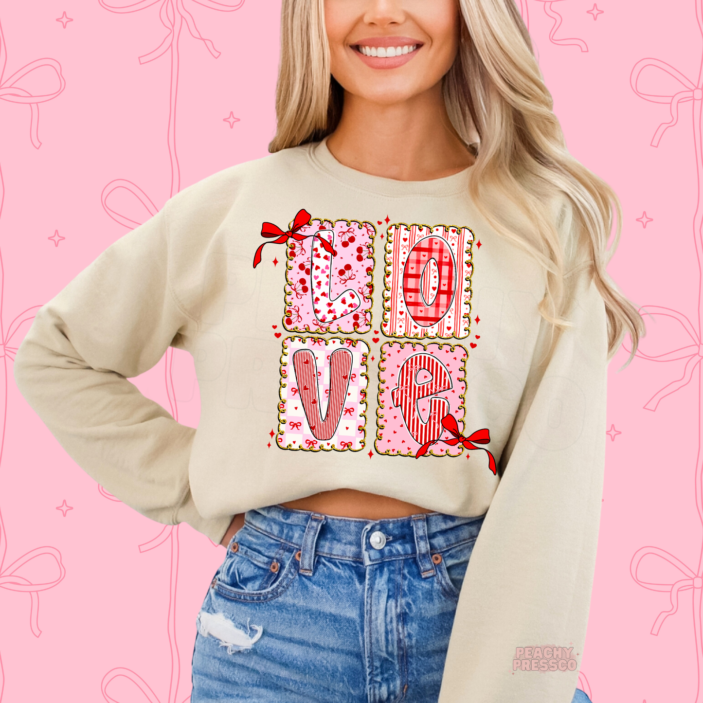 Sand sweatshirt showcasing a coquette LOVE patchwork graphic with pink hearts, bows, plaid patterns, and vintage-inspired Valentine's style.