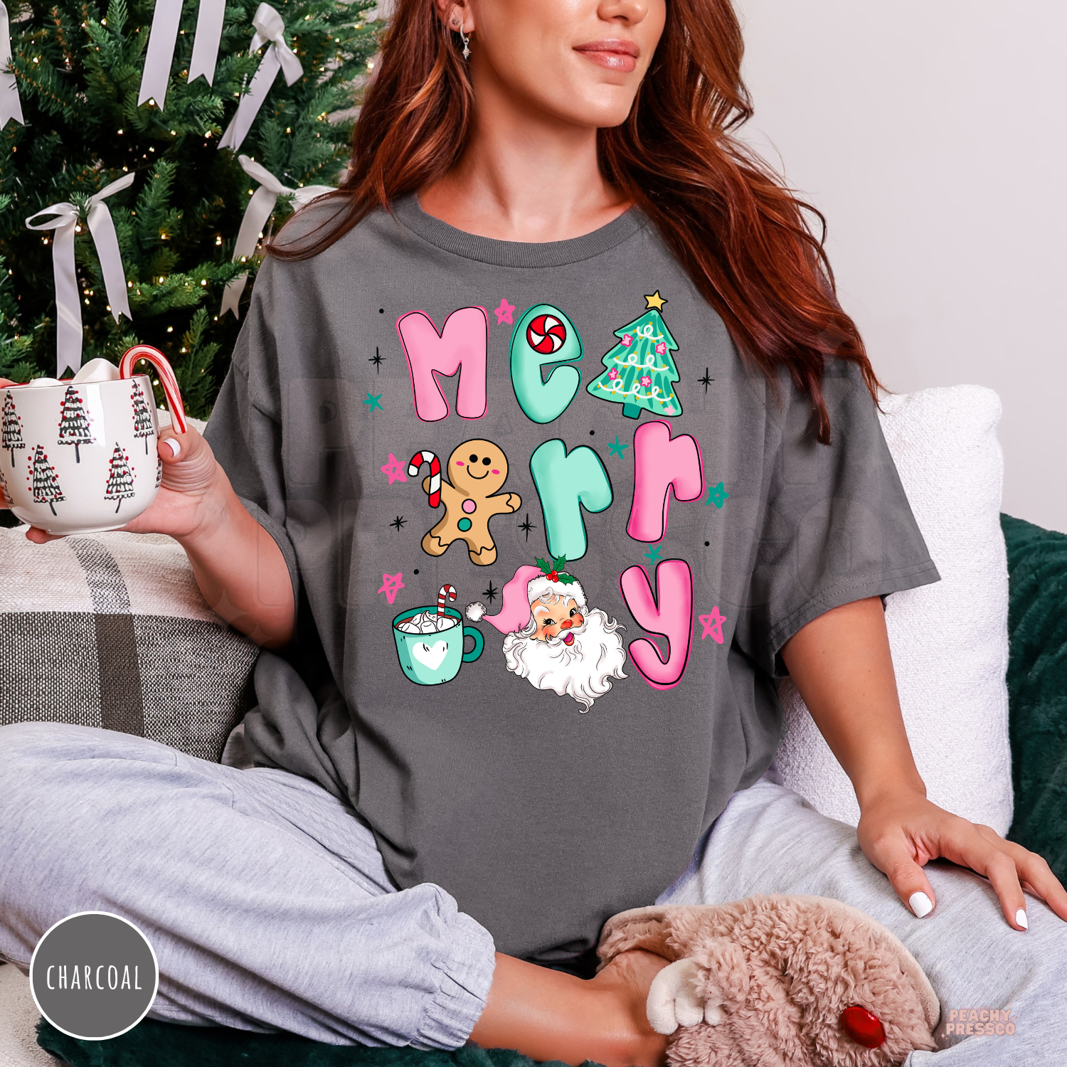 Model sitting on a couch wearing a charcoal gray oversized vintage Merry Christmas t-shirt paired with grey loungewear.