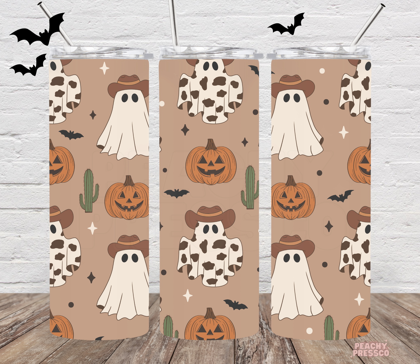 20oz skinny tumbler with repeating cowboy ghost, cow print ghost, pumpkins, bats and cactus western Halloween pattern.